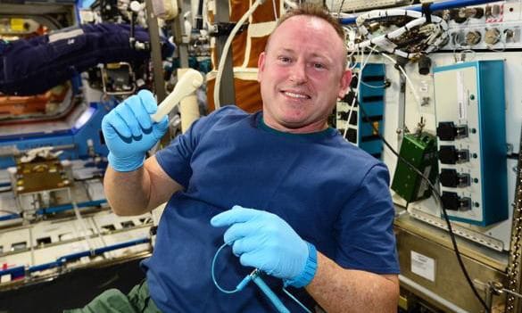 International Space Station Expedition 42 Astronaut Commander Barry "Butch" Wilmore shows off 3D printed wrench in space.